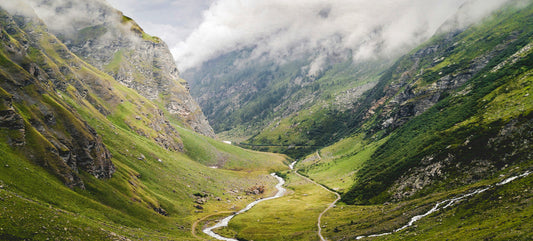 A valley surrounded by mountains with a river running through the bottom